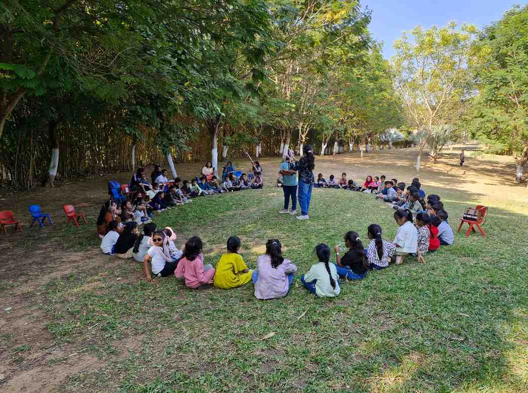 Children sitting in a circle in nature