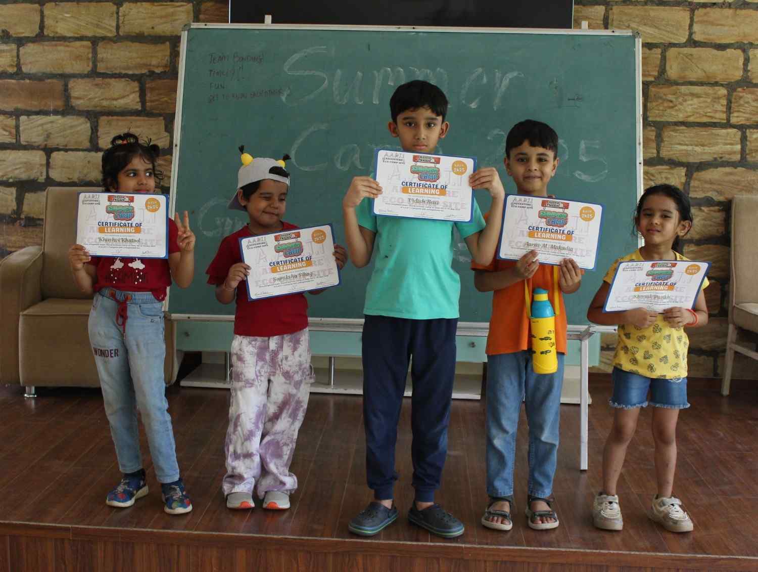 Children holding their summer camp certificates