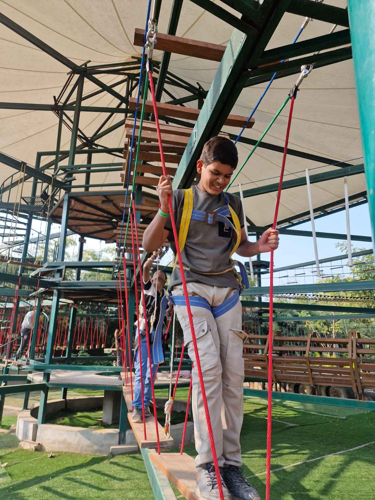 Boy on adventure rope bridge