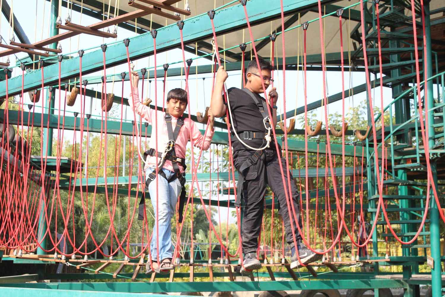 Boys navigating ropes course