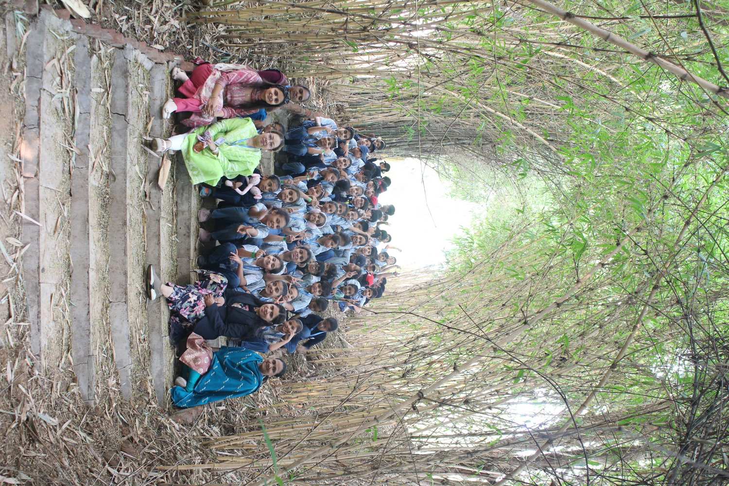 Class photo seated on bamboo forest stairs