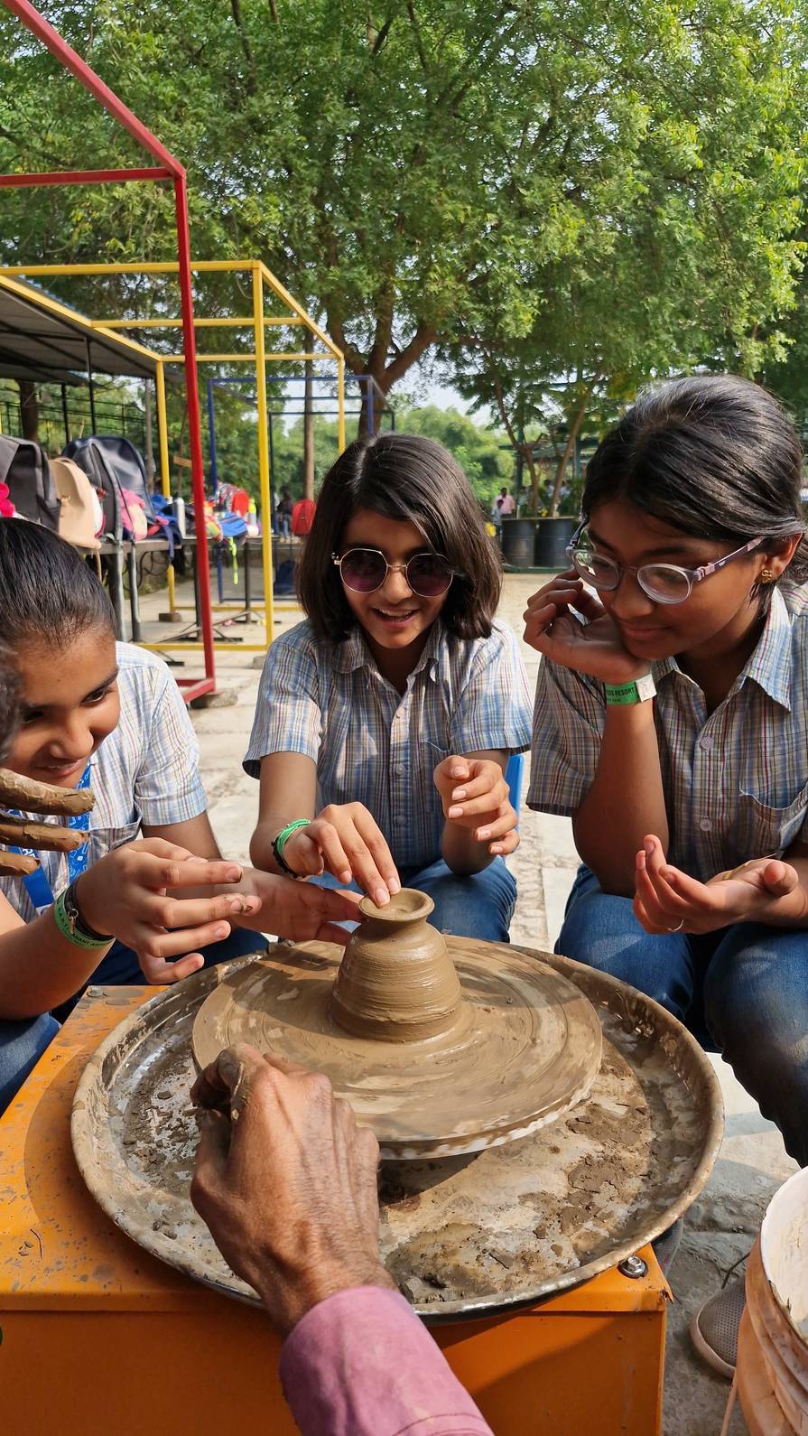 Girls learning pottery making skills