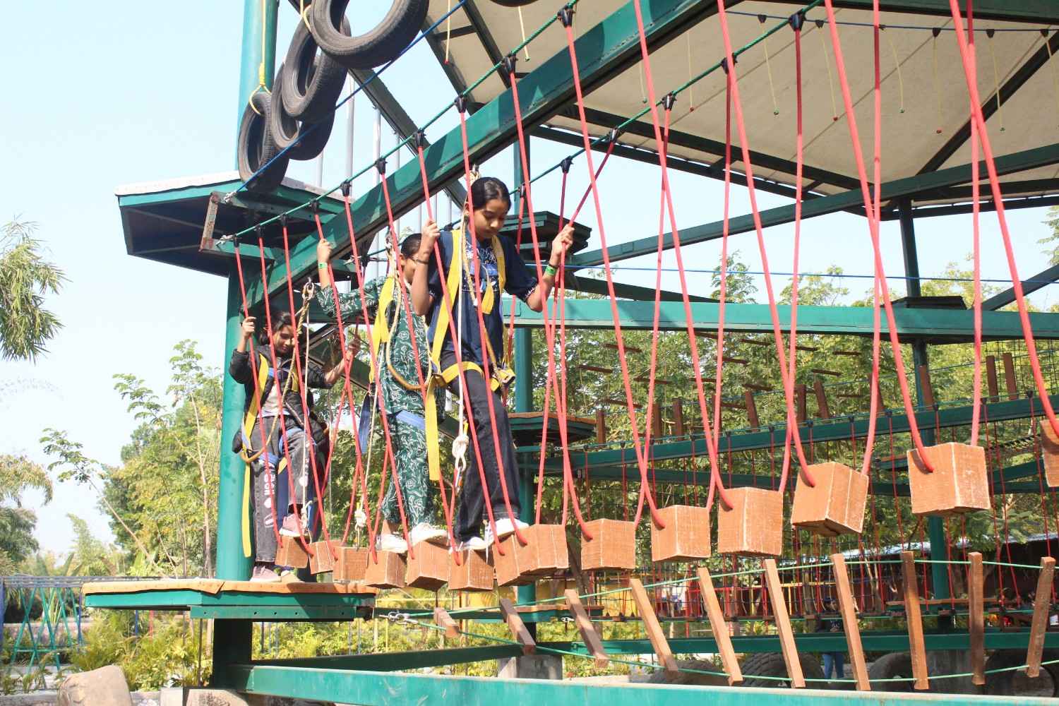 Girls on wooden block bridge