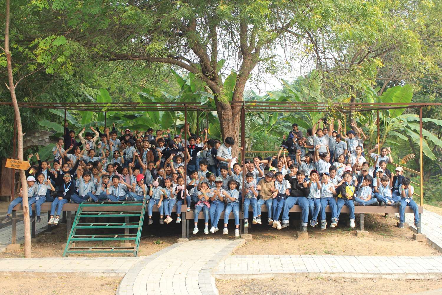 Large group of students cheering on wooden deck