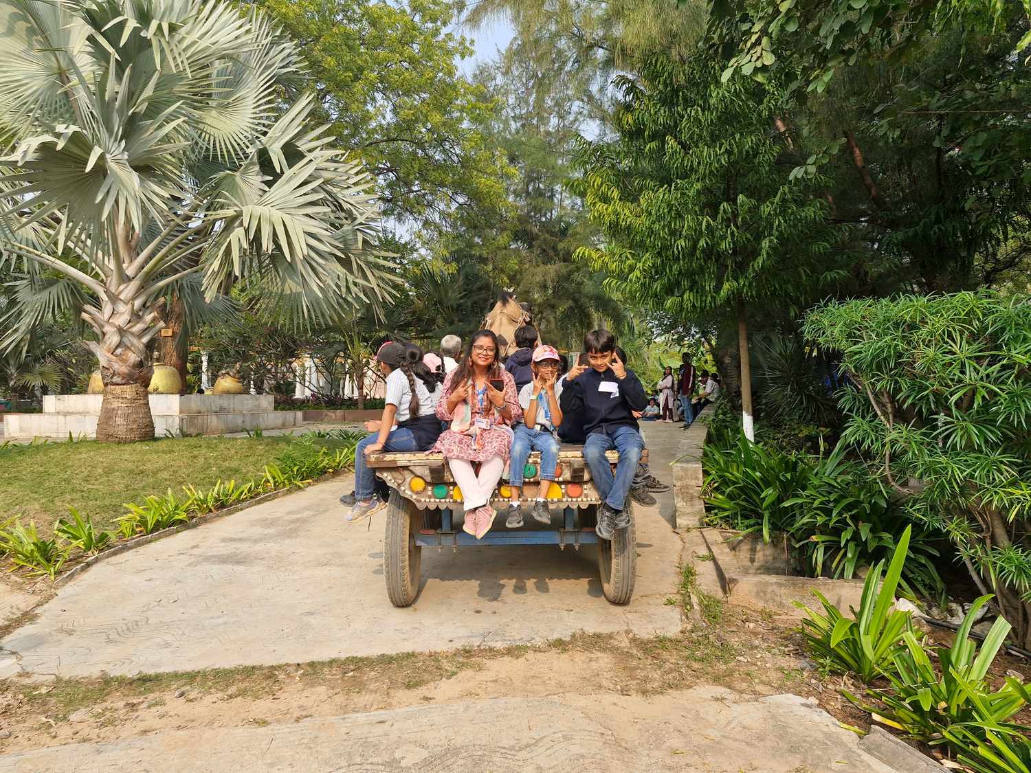 Group of students sitting on camel cart