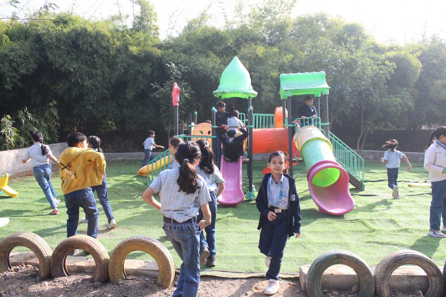 Children playing on playground slides and swings