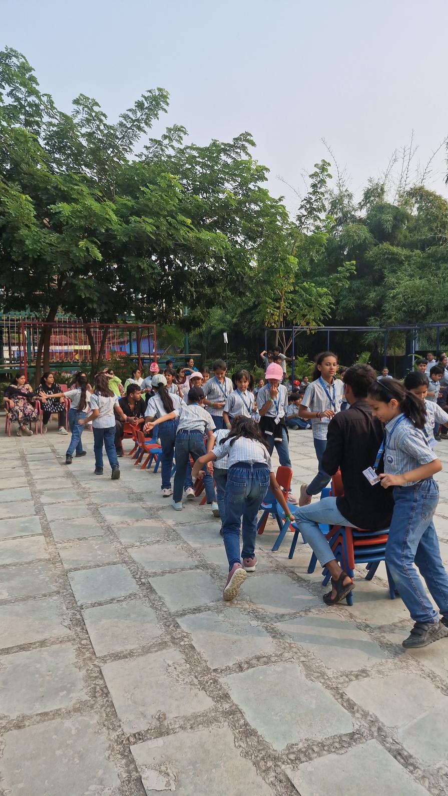 Students playing musical chairs game outdoors
