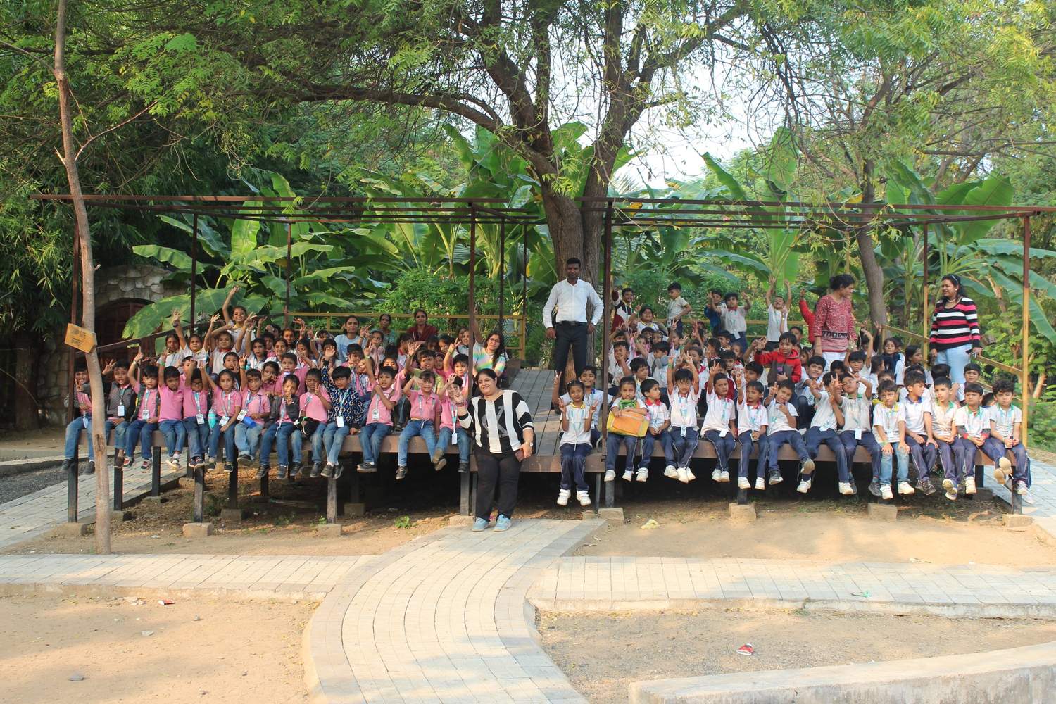 Group photo of students in pink uniforms on deck