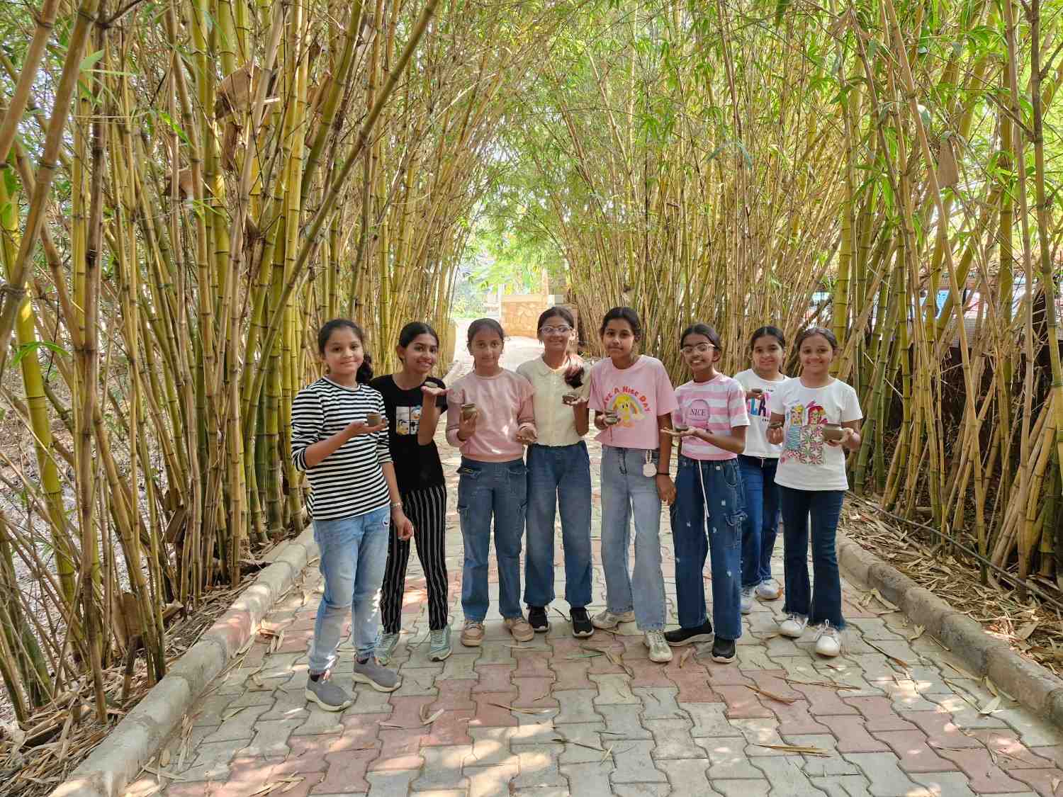 Students showing pottery in bamboo tunnel