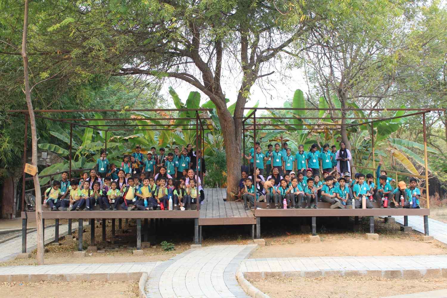  school students and teachers group photo at outdoor nature campsite