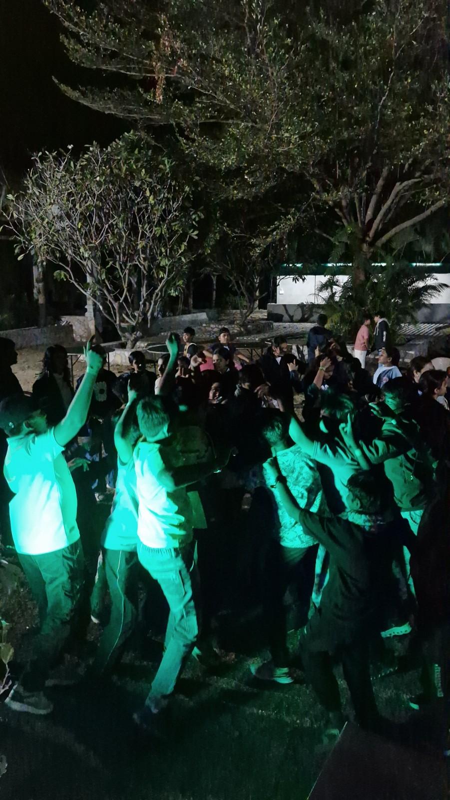 Students dancing at night event