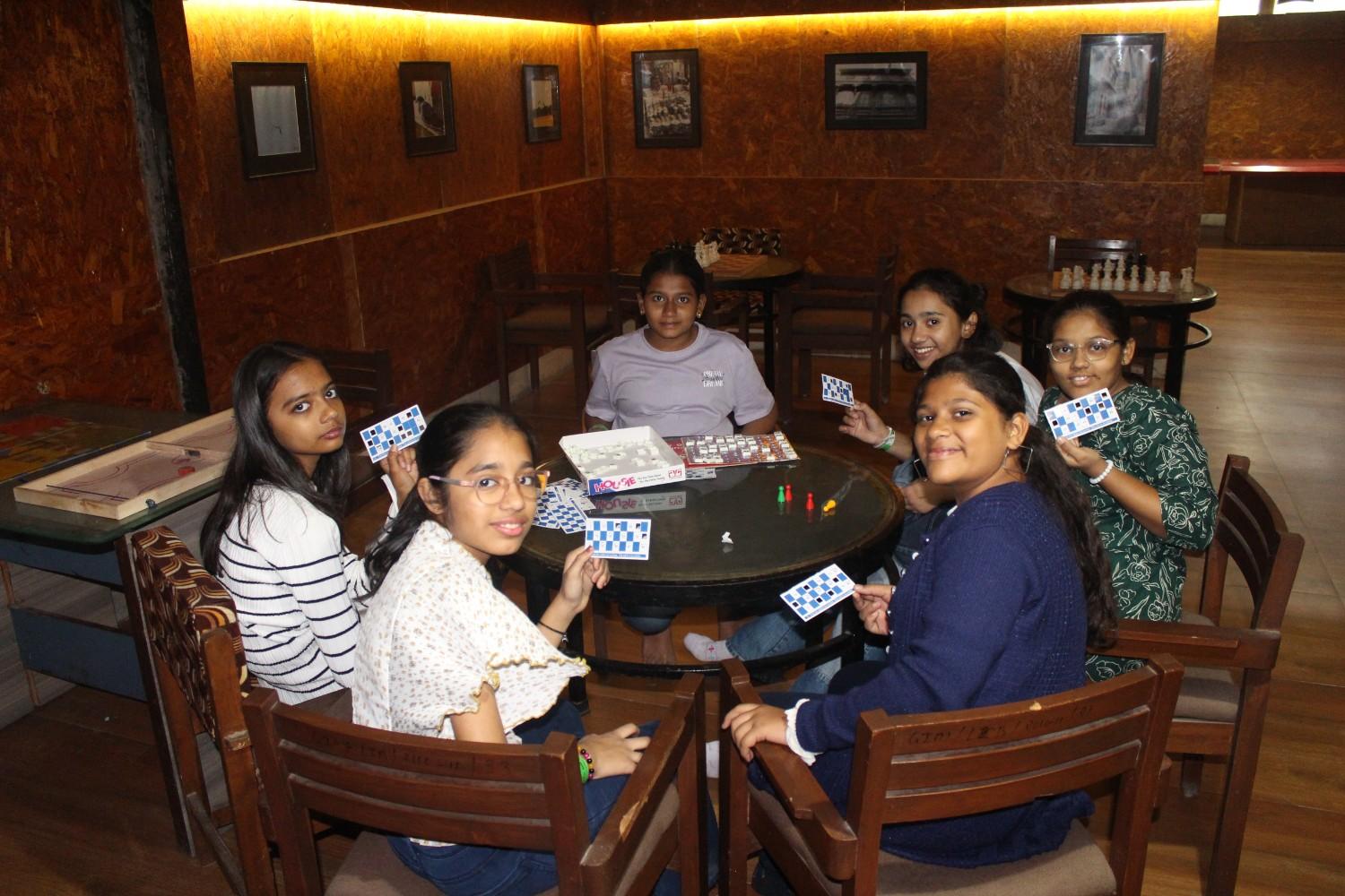 Students playing cards indoors