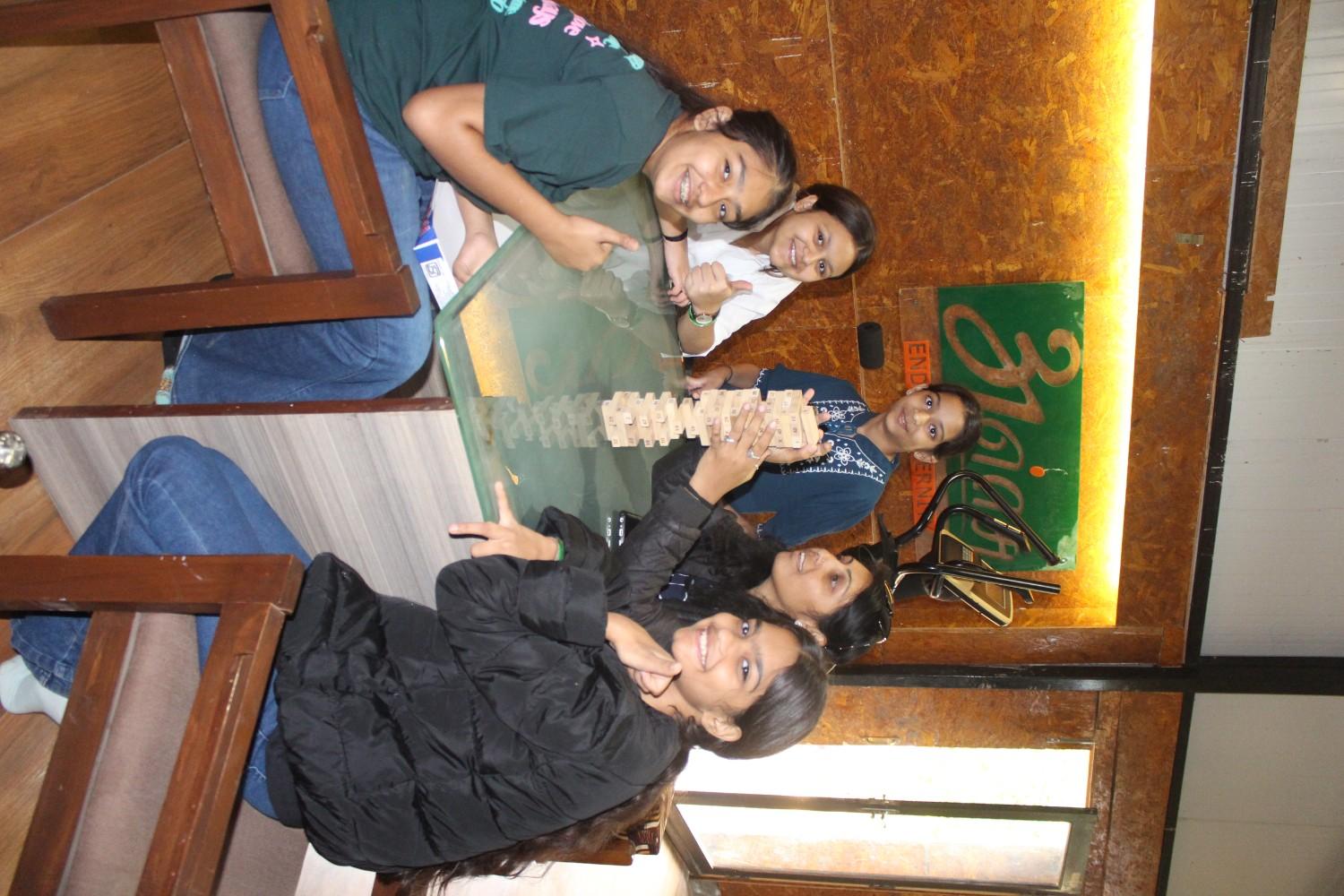 Students playing Jenga stacking game