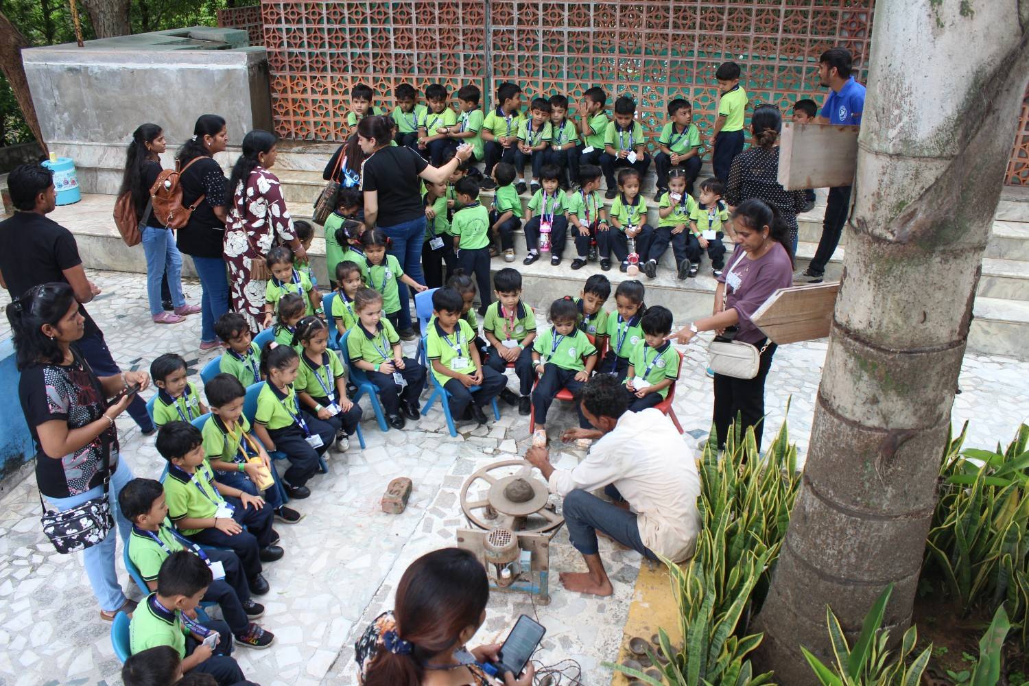 Students watching pottery wheel demonstration