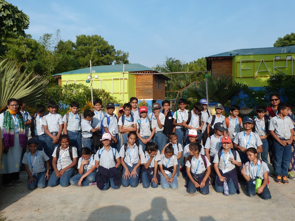 Class group photo in front of yellow resort cottages