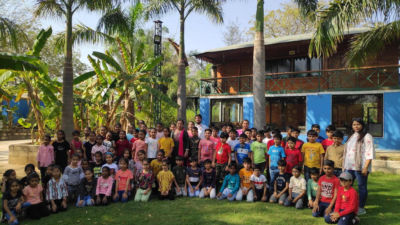 Full group photograph in front of the resort building