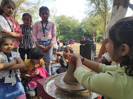 Girl student learning pottery wheel techniques