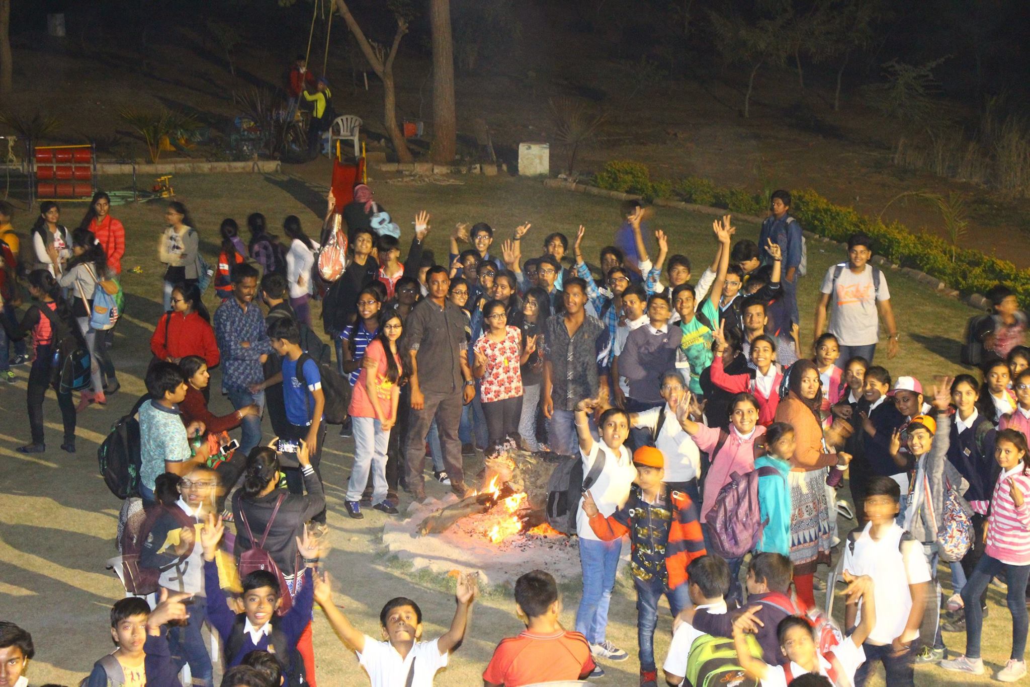 Large group gathering on the lawn at night