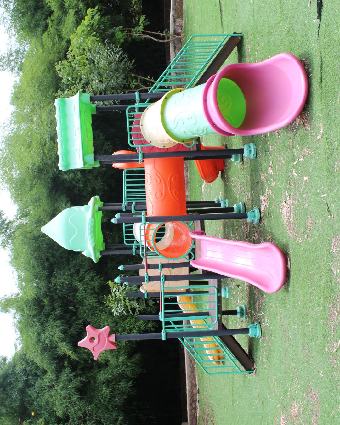 Colorful plastic playground slide and climbing structure